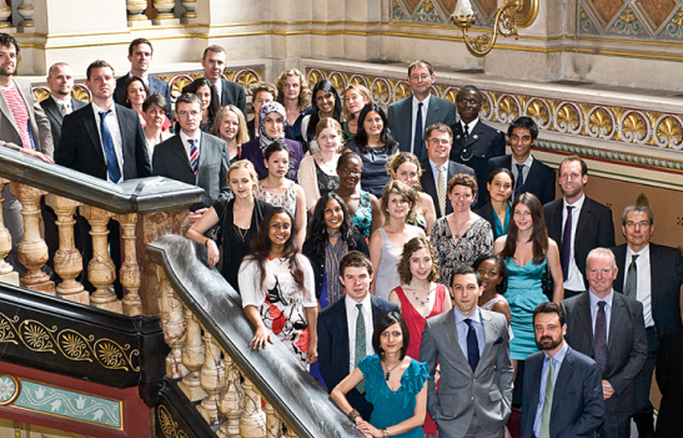 Crowd of people posing for a photo on a staircase