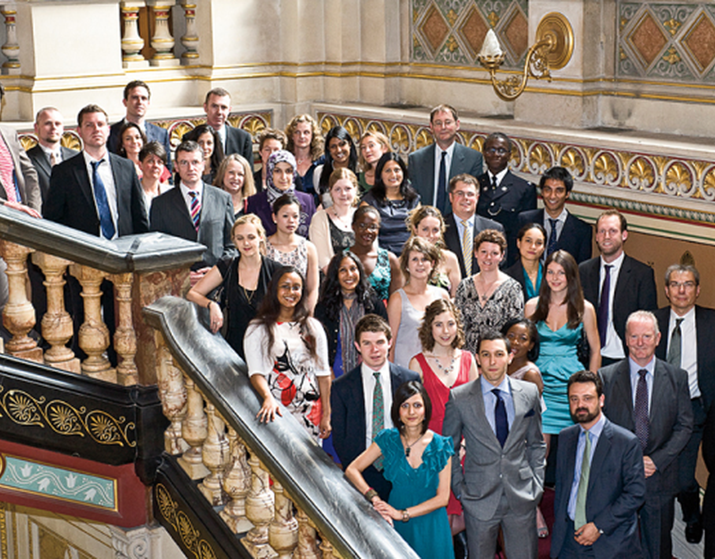Crowd of people posing for a photo on a staircase