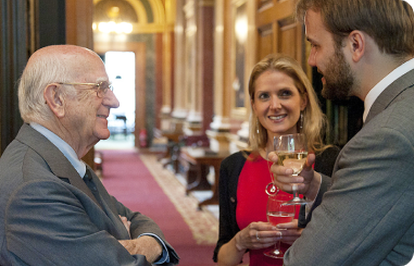 Three people talking and enjoying drinks